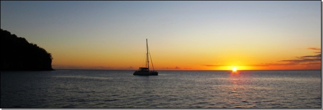 Sunset with a catamaran at the anchorage in Anse Chaudière, Martinique